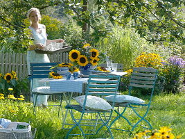 Table decoration with sunflowers under an apple tree