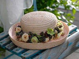 Straw hat with wreath of pink (roses), hydrangea (hydrangea), oregano