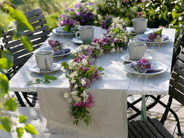 Late summer table decoration with flower garland