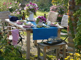 Late summer table decoration with hops and garden cosmos