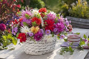 Autumn bouquet in a white basket with handles
