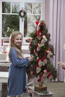 Girl with stylised Christmas tree as Advent calendar