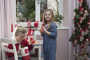Mädchen packen Nikolaus-Geschenke aus