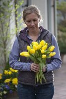 Woman with yellow tulip bouquet