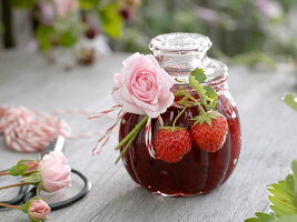 Glass with strawberry jam, decorated as a gift
