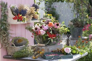 Wire basket with freshly cut herbs and berries