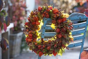 Autumn wreath of physalis (lampion fruits), rose (rose hips)