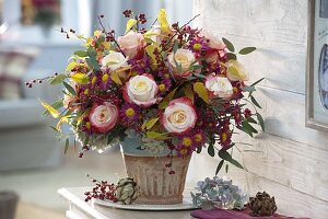 Autumn bouquet with pink (roses), Cotoneaster (dwarf medlar) with berries