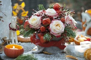 Autumn bouquet with pink (roses and rosehips), physalis (lanterns)