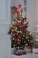 Abies nordmanniana (Nordmann fir) decorated with white and red baubles