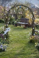 Rose arch with eggs, wreath of Salix (willow) and wooden Easter bunny