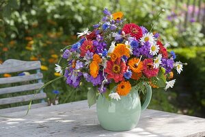 Woman making colourful summer bouquet