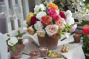 Bouquets of freshly cut pink placed in clay pots