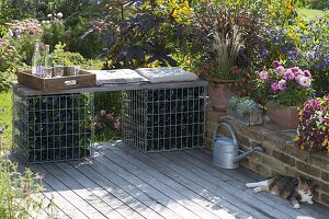 Self-made bench made of gabions filled with empty bottles