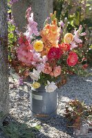 Late summer bouquet of gladiolus, roses and rosehips