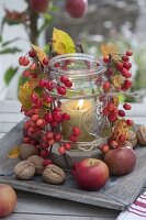 Old preservin jar as a lantern with Malus, candle and sand