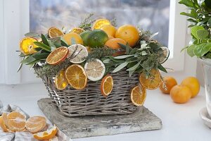 Basket with citrus (oranges and limes), dried orange slices
