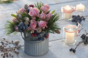 Autumn bouquet with pink (roses, rosehips), sloes (Prunus spinosa)