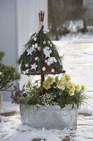 Christmas tree made of upside down basket on stick, decorated with pine tree