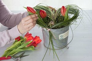 Valentine's bouquet made of red tulips in grass-heart