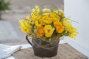 Yellow scented bouquet of Ranunculus (ranunculus), Acacia (mimosa)