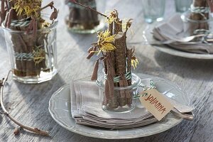 Table decoration with witch hazel and hazel twigs