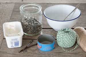 Birdseed in various containers to hang up