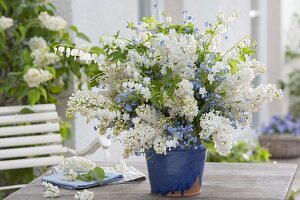 White-blue scented bouquet in handmade pottery: Syringa (Lilac)