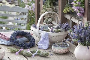 Wreath of lavender (Lavandula) and basket with flowers, lavender bottles
