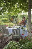 Flower garden table setting under walnut tree