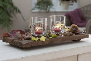 Elongated wooden bowl with lanterns, glasses with etched motifs