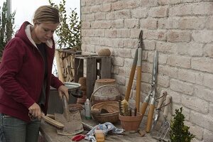 Woman cleaning spade with a brush