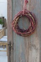 Wreath of different-colored branches of cornus on door