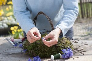 Easter nest with wooden rabbit made of moss wreath and birch branches