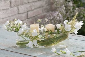 Elongated glass bowl as lantern with campanula (bellflower)