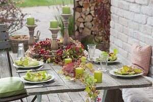 Table decoration with rosehips and wild wine