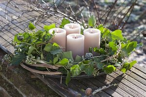 Advent wreath made from Hedera, and clematis tendrils with beige candles