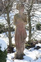 Woman figure made of terracotta in the wintry garden