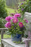 Herb bouquet with peonies in a salt-glass pot, alchemilla