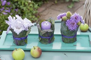 Small table decoration with bouquets and lantern on turquoise coaster