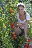 Plant tomatoes and marigolds in an organic garden bed