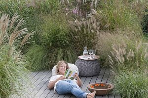 Wooden terrace with grassy bed as a screen