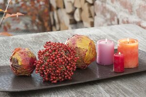 Autumn balls tied from colorful leaves and roses