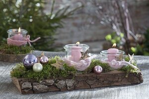 Wooden board with moss, baubles, bark stars