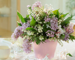 Fragrant bouquet tied with Convallaria majalis, Syringa vulgaris