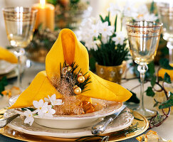 Yellow napkin, Narcissus tazett daffodils, Pinus pine twigs, Angel hair