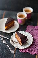 Slices of vegan Sacher cake with apricot filling
