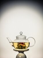 Tea with flowering tea in a glass jug