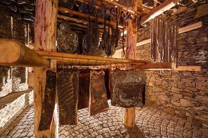 Bacon and sausages in the curing chamber at the Hofmanufaktur Kral in South Tyrol