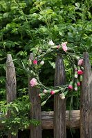 Wreath of carnations hung on wooden fence